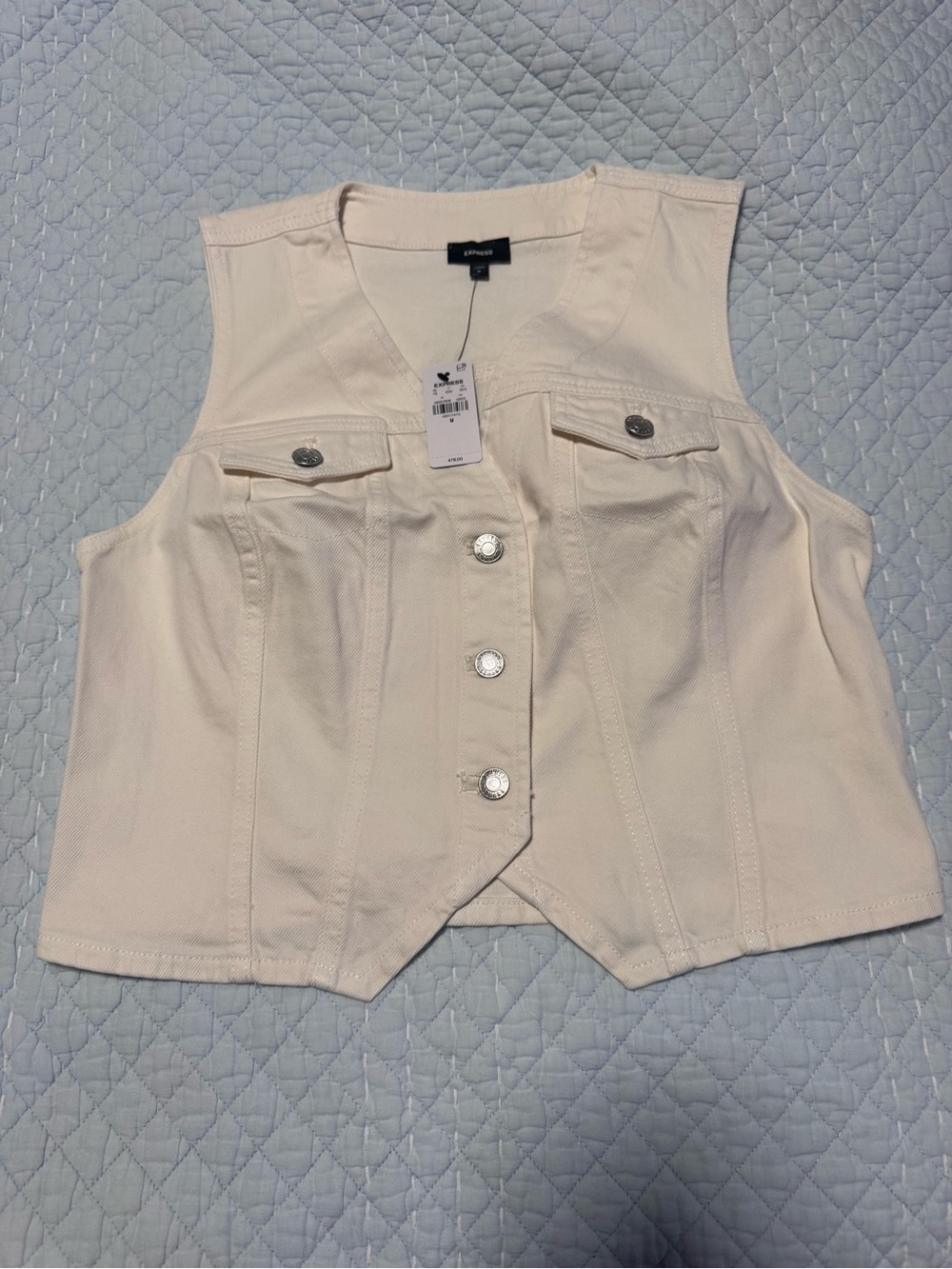 Express, women’s jean vest in cream.